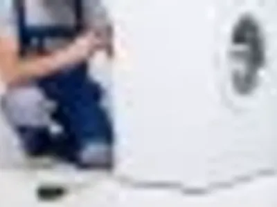 Electrician installing a washing machine