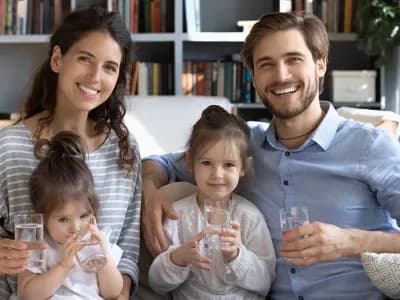 Young family sitting together on a couch