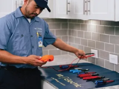 Mr electrician performs outlet repairs.