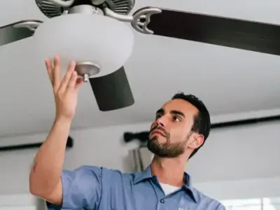 electrician repairing ceiling fan light