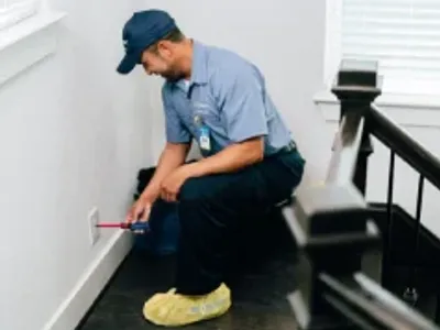 Electrician replacing an outlet cover.
