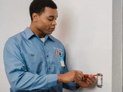 electrician repairing wall light switch