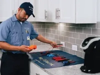Mr electrician performs outlet repairs.