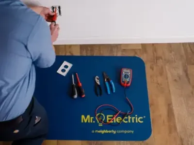 Home electrical repair service with electrician and tools for outlet repair