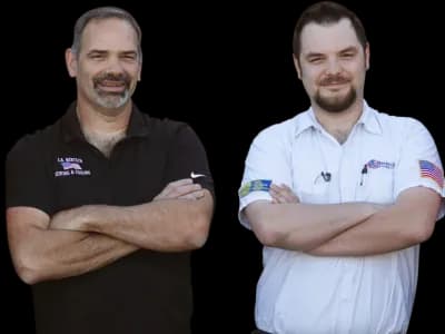 Two smiling J.A. Bertsch HVAC technicians, one wearing black and one wearing white.