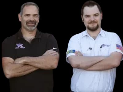 Two smiling J.A. Bertsch HVAC technicians, one wearing black and one wearing white.