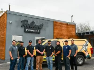 Reliant Plumbing San Antonio crew posing in front of shop and work truck