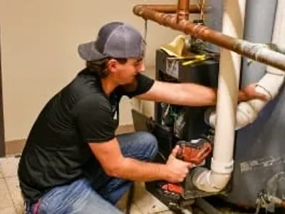 man fixing water heater