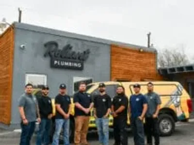 Reliant Plumbing San Antonio crew posing in front of shop and work truck