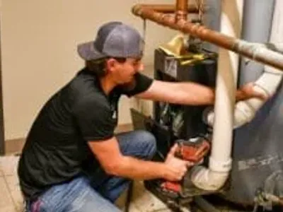 man fixing water heater