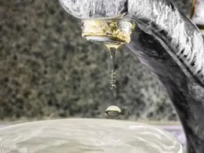 Signs of hard water buildup on a faucet