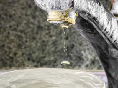 Signs of hard water buildup on a faucet