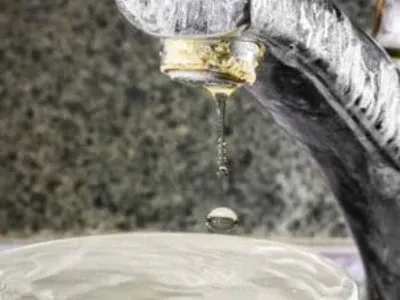 Signs of hard water buildup on a faucet