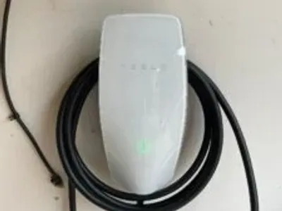 Tesla electric car charging at a home charging station