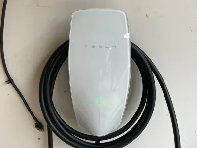 Tesla electric car charging at a home charging station