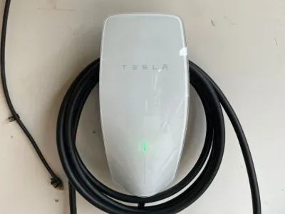 Tesla electric car charging at a home charging station