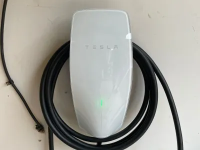 Tesla electric car charging at a home charging station