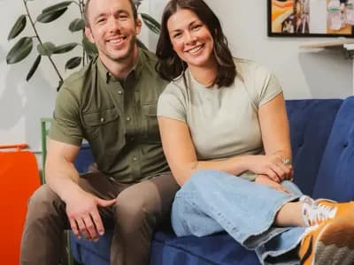 Danie and Ryan Turry sitting on a couch in an office