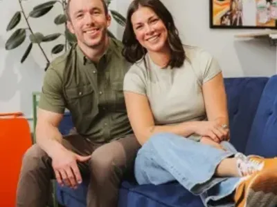 Danie and Ryan Turry sitting on a couch in an office