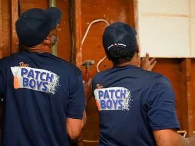 Worker inspection wiring behind drywall