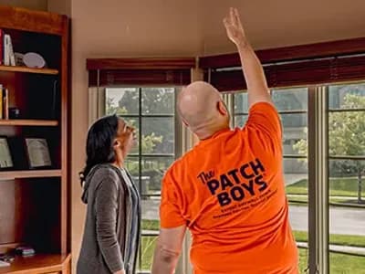 Technicion pointing to ceiling with customer