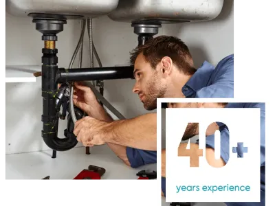 Fischer plumber and badge showing 40+ years of experience