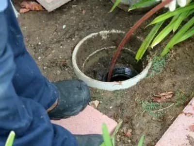 A Plumber Cleaning A Sewer Line