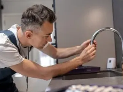 Plumber Installing Faucet
