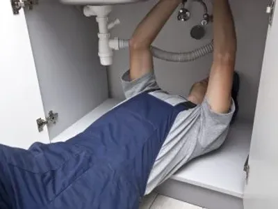 Plumber Fixing A Sink