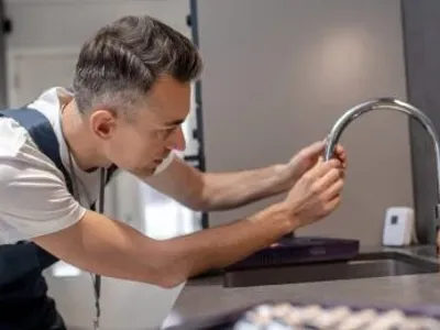 Plumber Installing Faucet