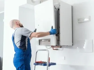 Plumber Installing A Boiler