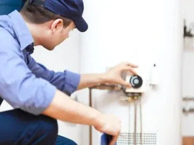 Plumbing Technican Checking Water Heater