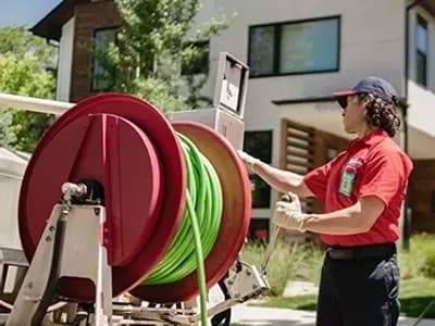 Mr. Rooter professional using a hose reel.