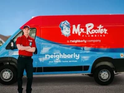 A smiling plumber in a red