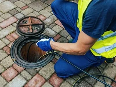 service worker cleaning blocked sewer line with hydro jetting