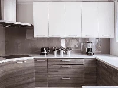 Modern kitchen with white and wood cabinets.