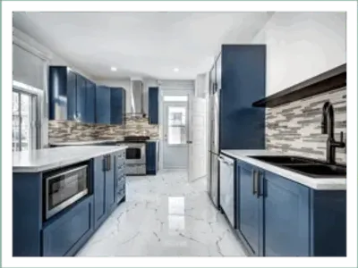 Modern kitchen with blue cabinets and appliances.