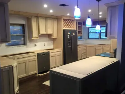 Modern kitchen remodel featuring custom cabinetry, under-cabinet lighting, and a central island, highlighting Ace Kustoms' craftsmanship and design aesthetics.