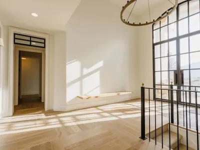 grand hallway with floor-to-ceiling windows by 10x builders in utah county