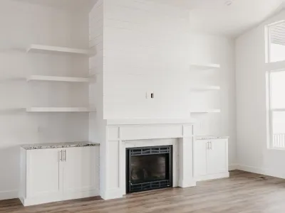 white fireplace with floating shelves by 10x builders in utah county