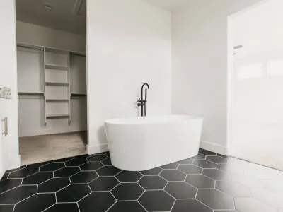 free standing tub with black & white tile by 10x builders in utah county