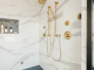 marble shower with gold hardware by 10x builders in utah county