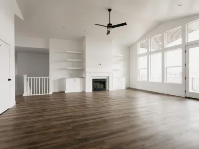 large living area with dark wood flooring by 10x builders in utah county