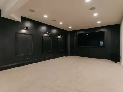 entertainment room with moody black walls by 10x builders in utah county