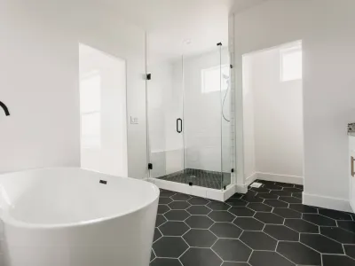 main bathroom with black & white hexagon tile by 10x builders in utah county