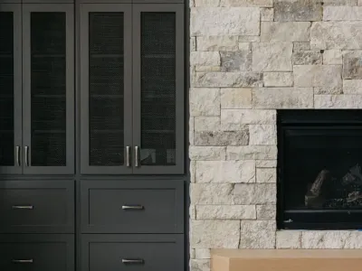stone fireplace with black cabinets by 10x builders in utah county