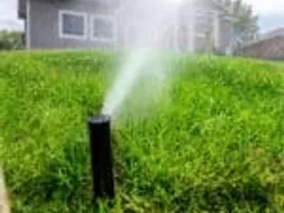 Irrigation system turned on in a residential backyard
