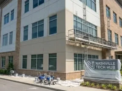 Professional commercial exterior painting on a Nashville office building with fiber cement and brick facade