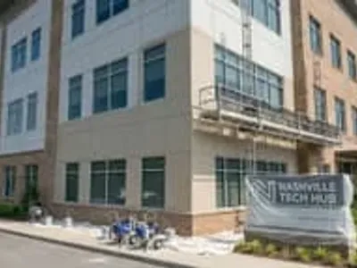 Professional commercial exterior painting on a Nashville office building with fiber cement and brick facade