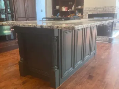 We painted this kitchen island in a new construction home. The slate black paint really stands out nicely.